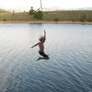 Kid enjoying swinging into a lake